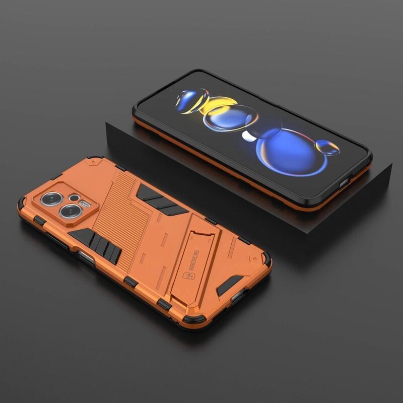 Héjálló hibrid borítás csuklós állvánnyal a Xiaomi Poco X4 GT 5G-hez - narancssárga